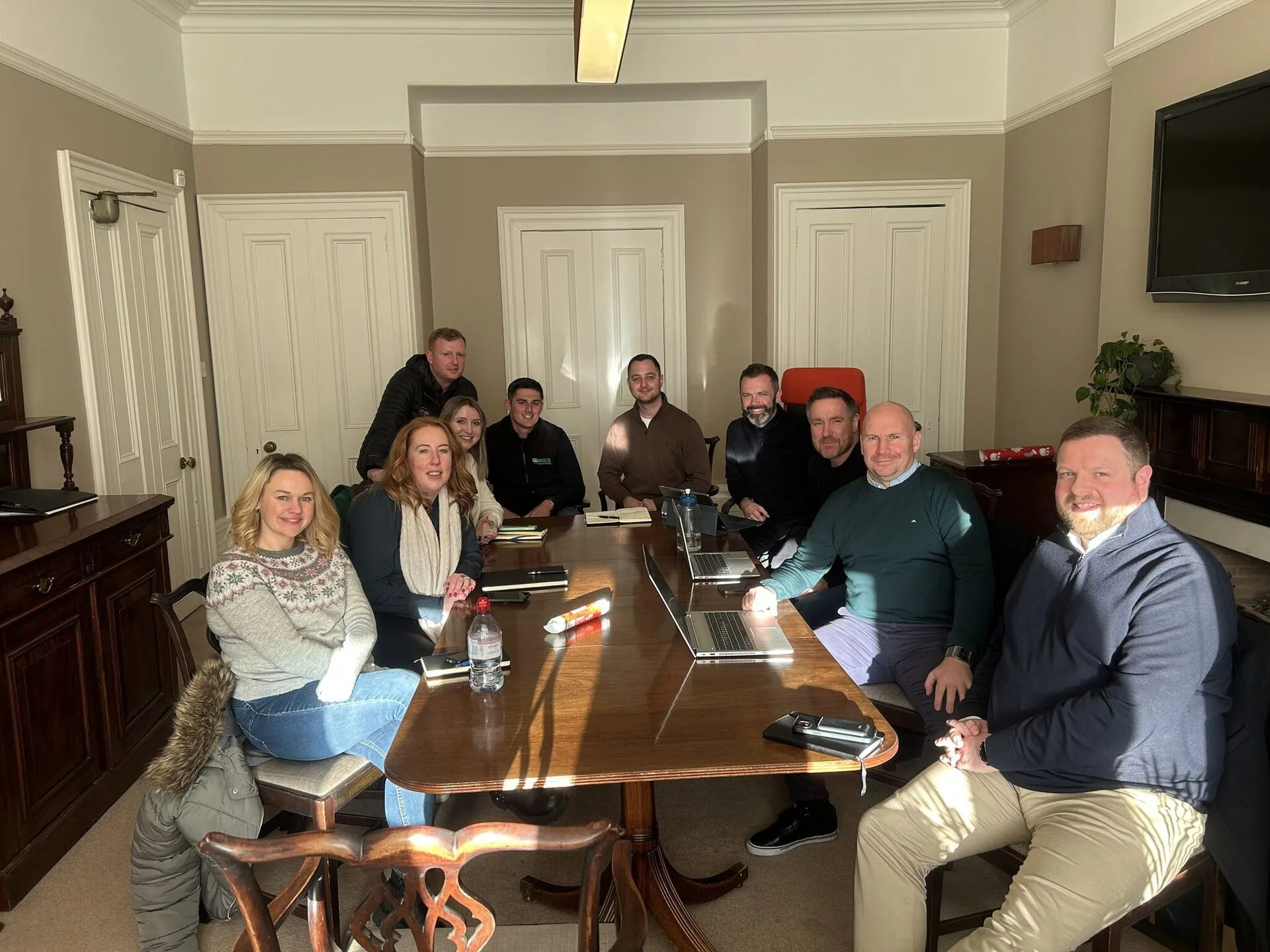 Gten group meeting around a wooden table